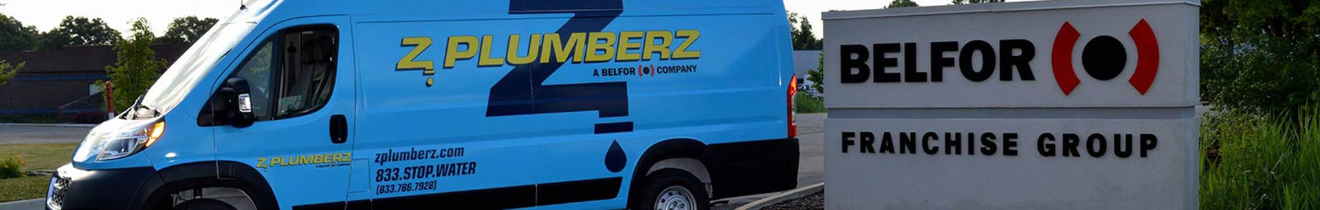ZPlumberz Van next to Belfor Franchise Group Sign