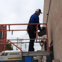 a man working on the outside of a building