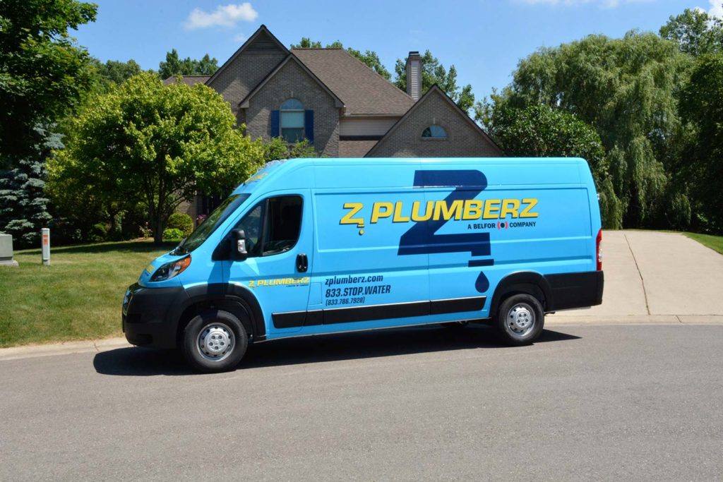 Z PLUMBERZ franchise van in front of home / Young Plumbers