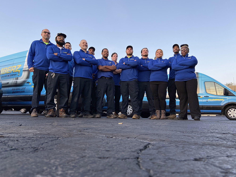 Z PLUMBERZ franchise plumbers stand in front of van
