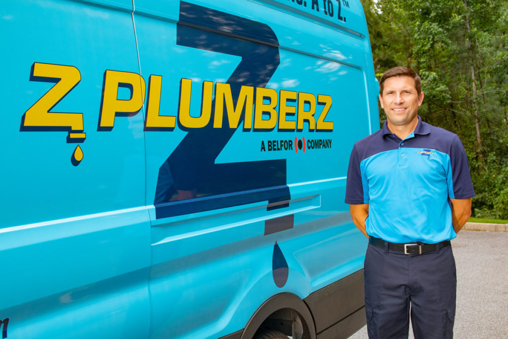 Z PLUMBERZ franchise owner in front of car